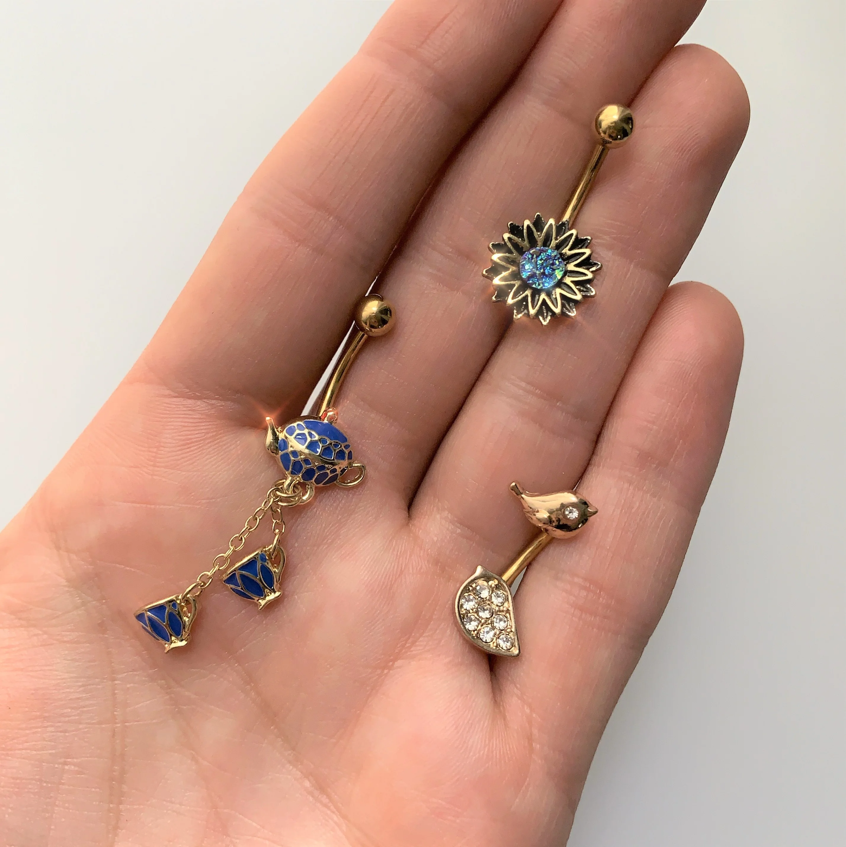Gold Tone Aqua Center Sunburst Flower Belly Ring - Image 2
